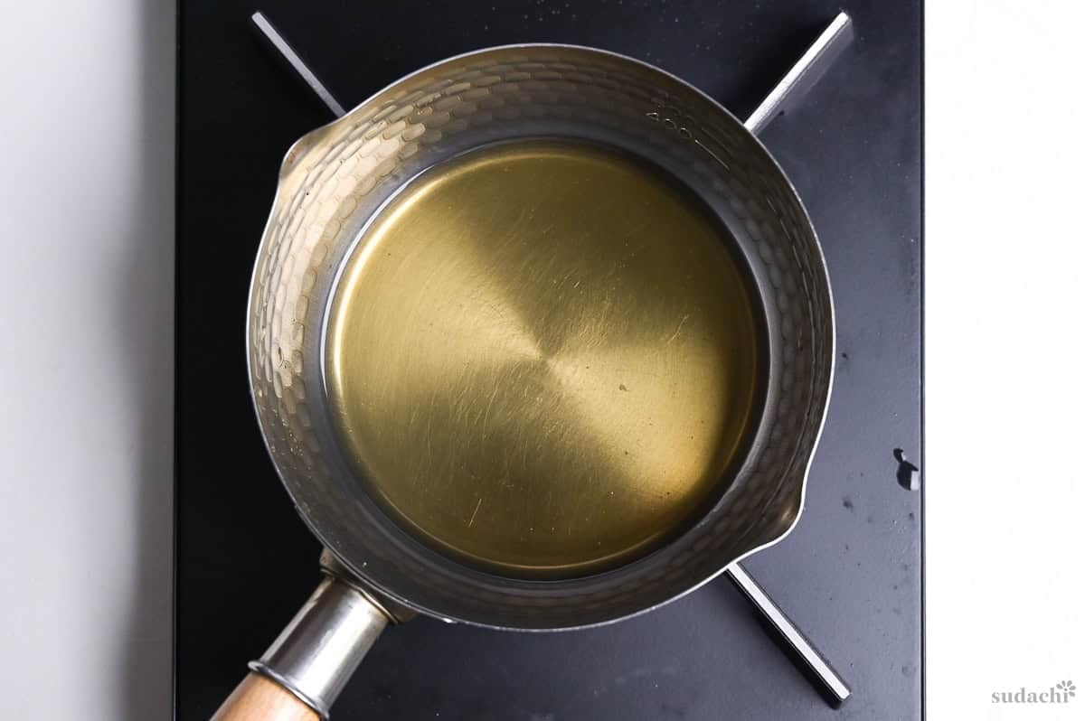 Making broth for duck soba noodle soup in a pot on the stove