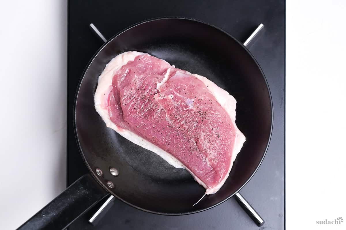 duck breast skin-side down in a frying pan on the stove