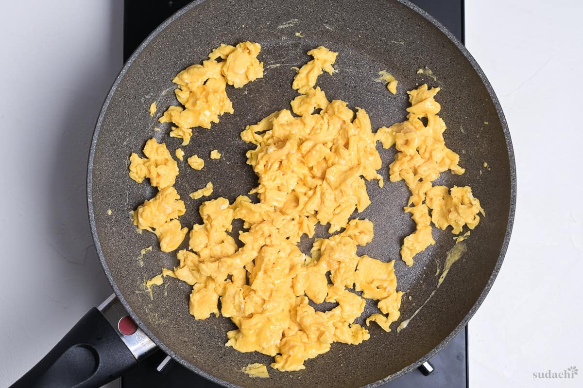 scrambled egg in a frying pan on the stove top.