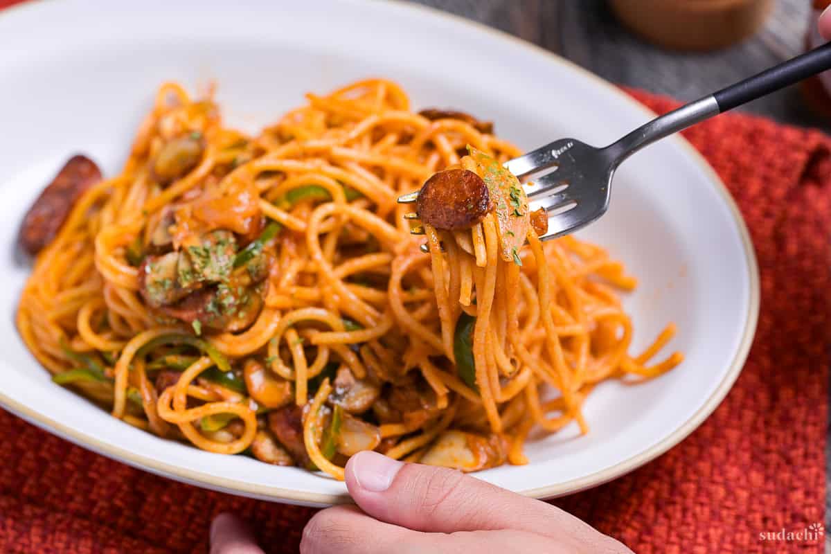 Lifting Spaghetti Napolitan on a fork