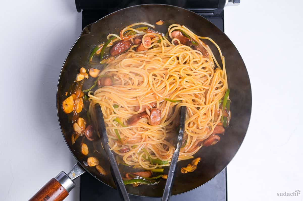 Spaghetti Napolitan in a wok on the stove top.