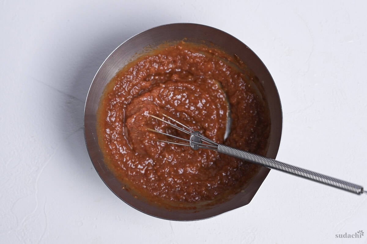 spicy miso marinade mixed in a steel mixing bowl with mini whisk