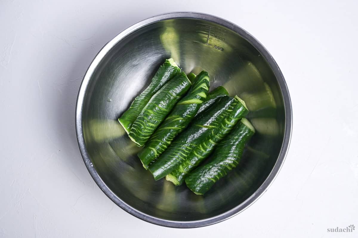 drained accordion cucumbers in a steel mixing bowl