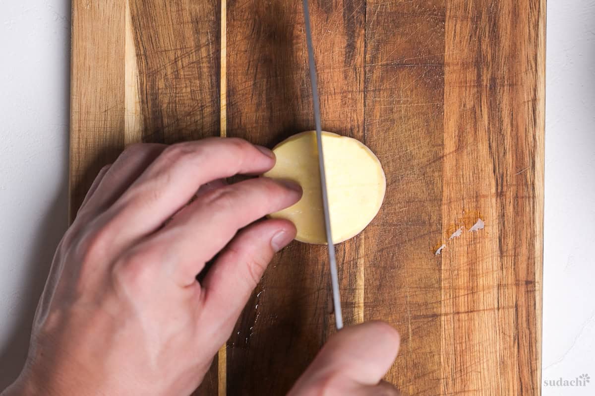 making a cross incision on a Japanese sweet potato round