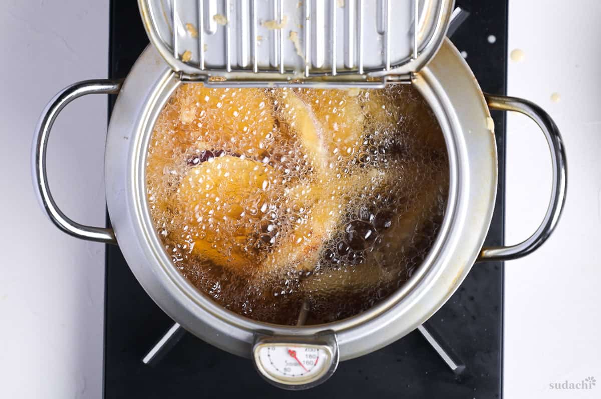 Japanese sweet potato tempura frying in a pot