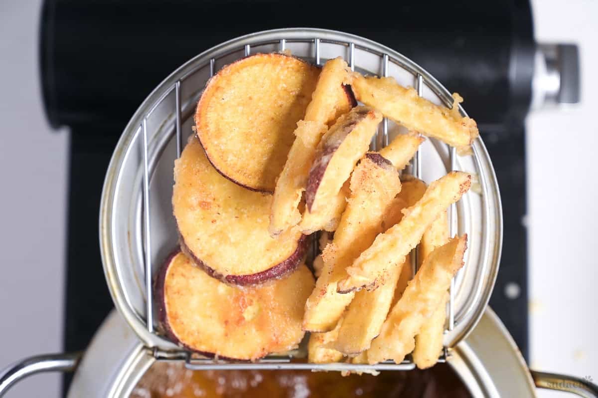 Japanese sweet potato tempura draining on a wire rack