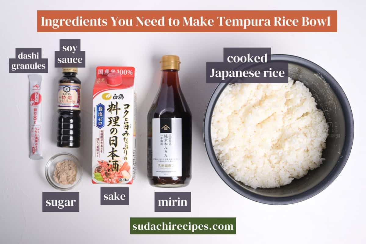 Ingredients needed to make tempura rice bowl on a white background with labels. From top to bottom, left to right: dashi granules, soy sauce, cooked Japanese rice, sugar, sake, mirin.