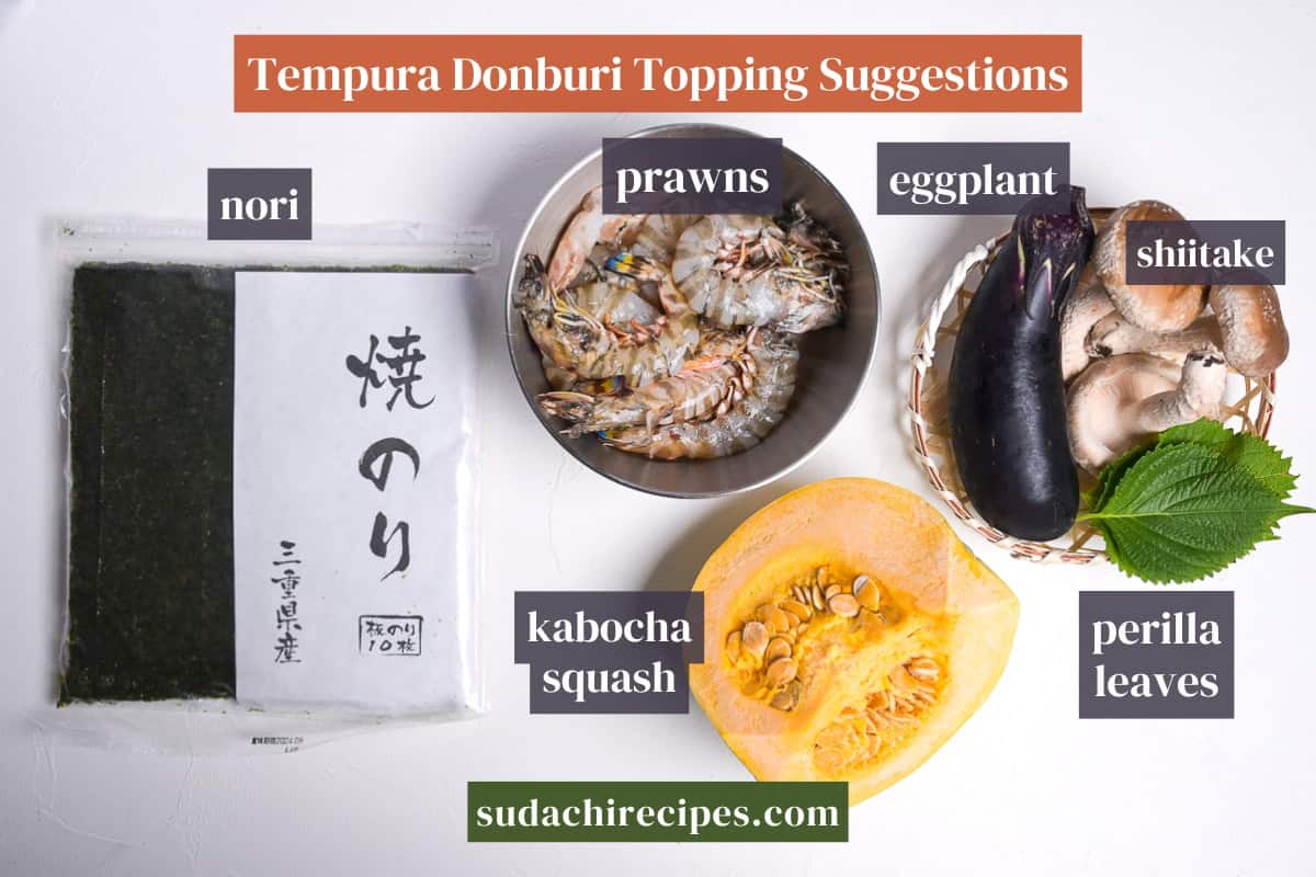 Suggested ingredients for tempura donburi on a white background with labels. From top to bottom, left to right: nori, prawns, eggplant, shiitake, kabocha, perilla leaves.