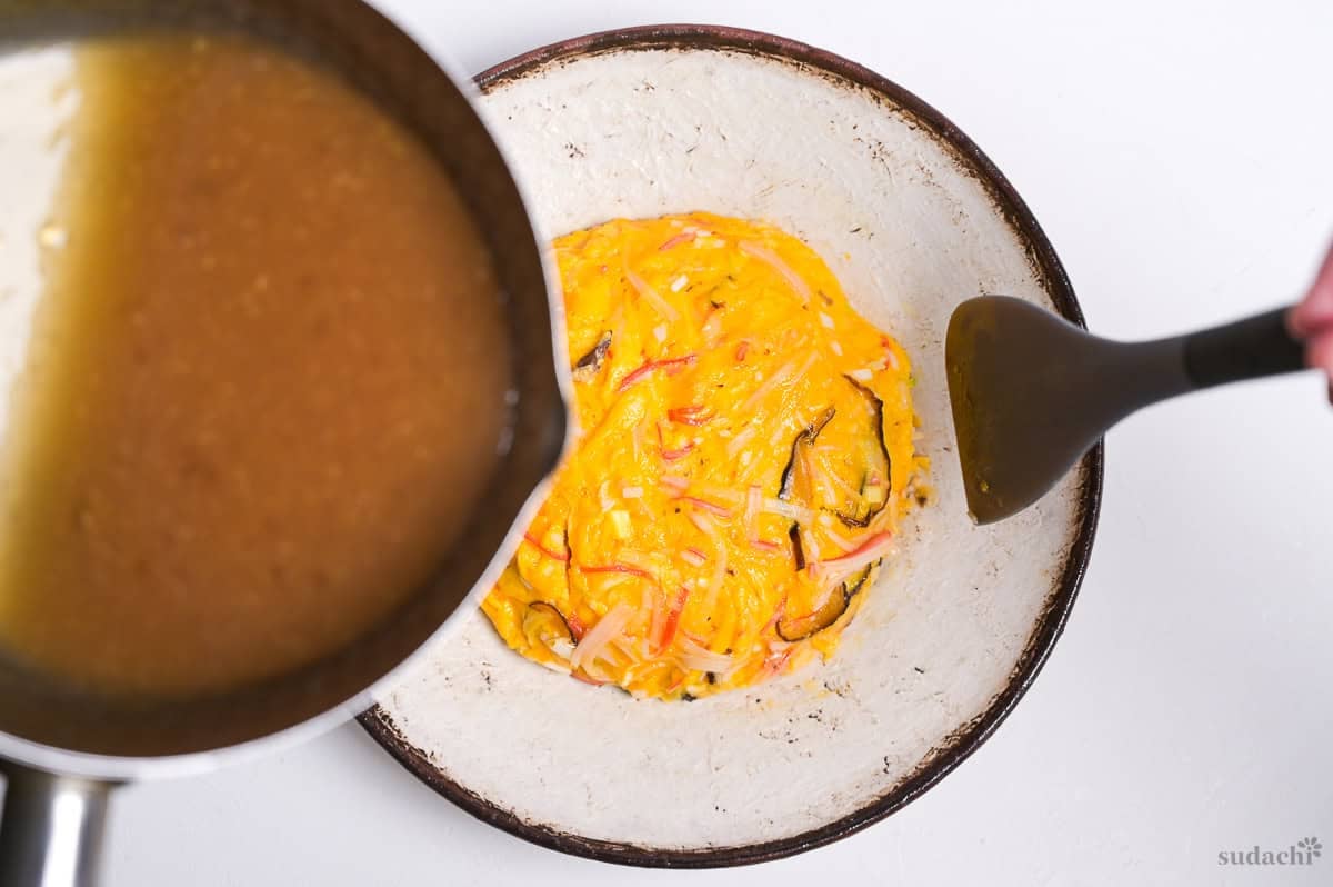 pouring sauce over tenshinhan on a plate