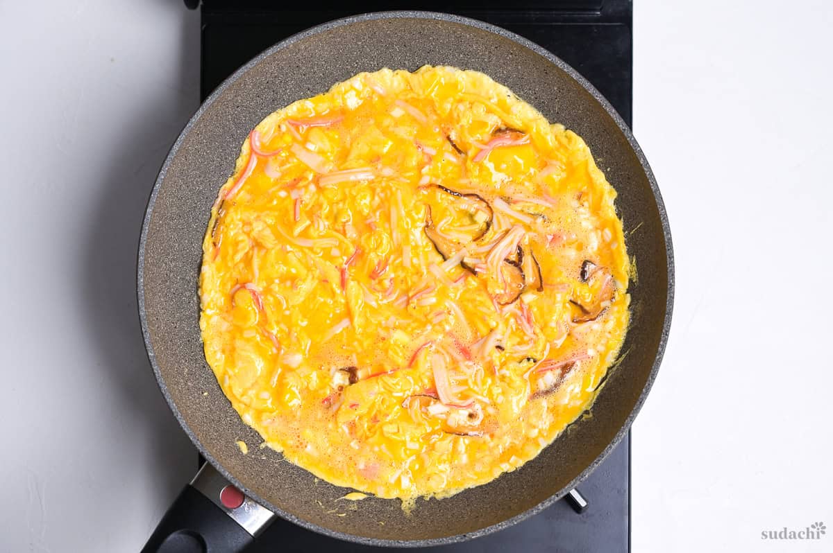 frying crab omelette for tenshinhan in a frying pan on the stove top