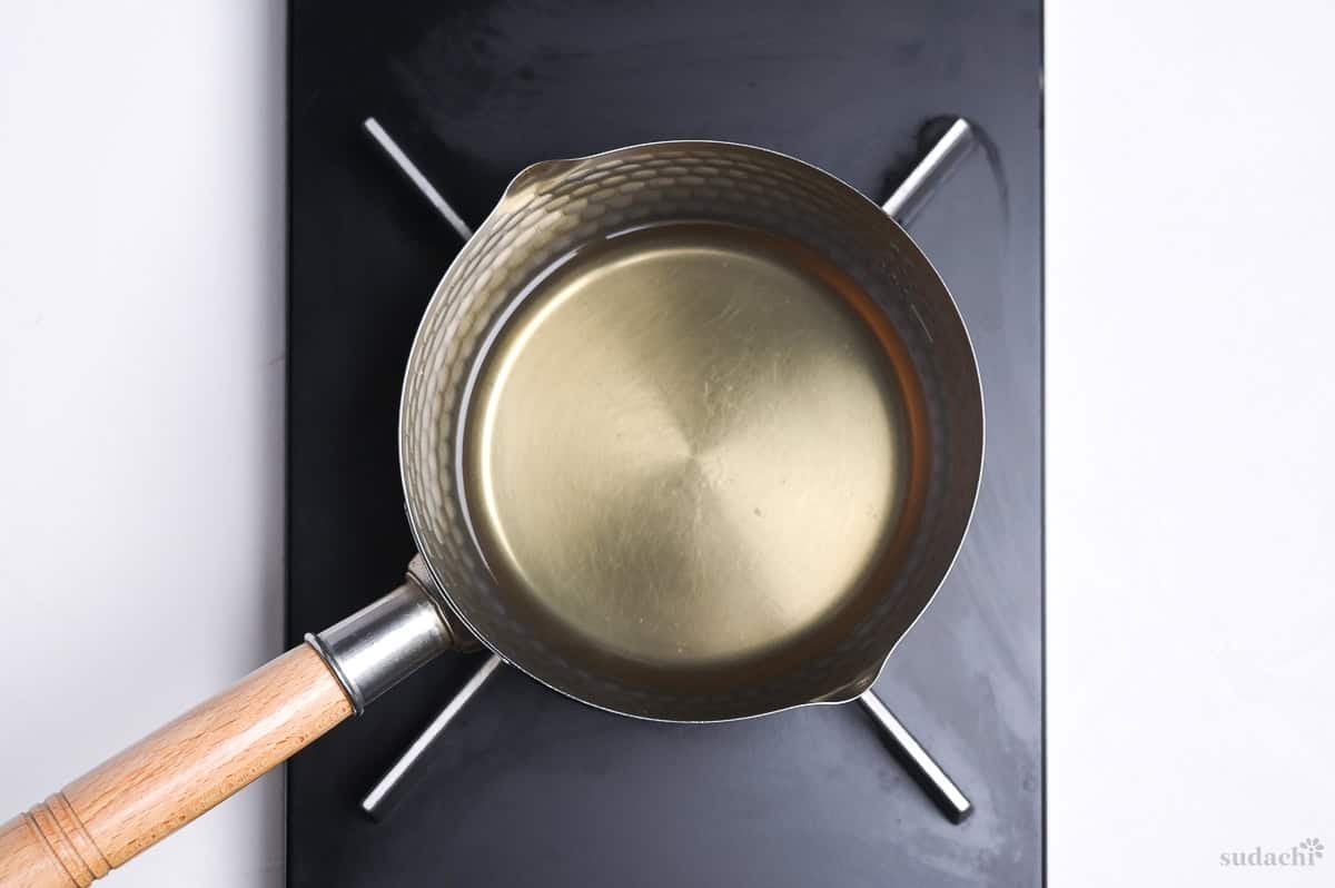 heating dashi in a sauce pan on the stove top