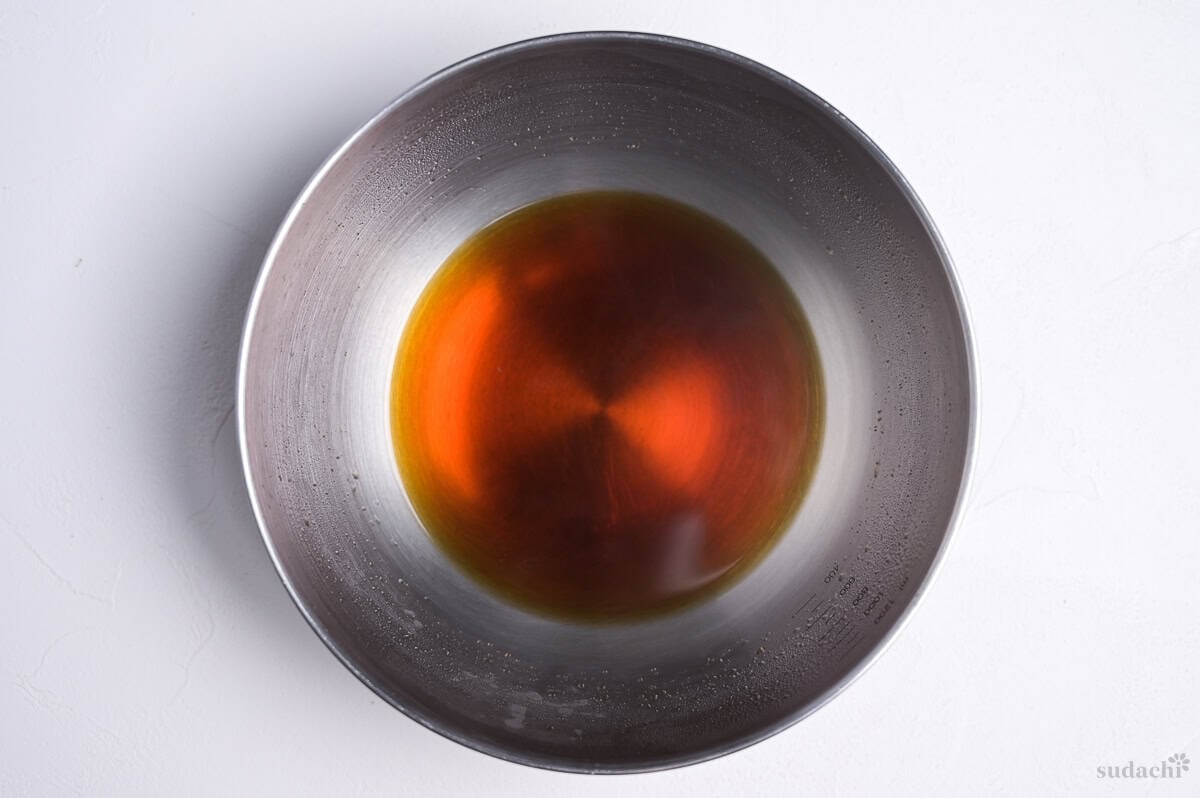 strained homemade tentsuyu tempura dipping sauce in a steel bowl
