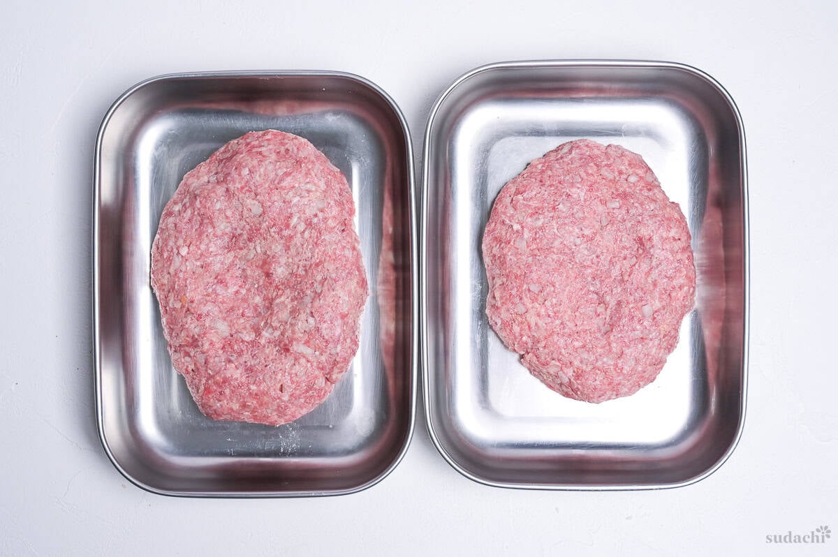 two shaped patties in separate steel containers to make homemade wafu hamburg