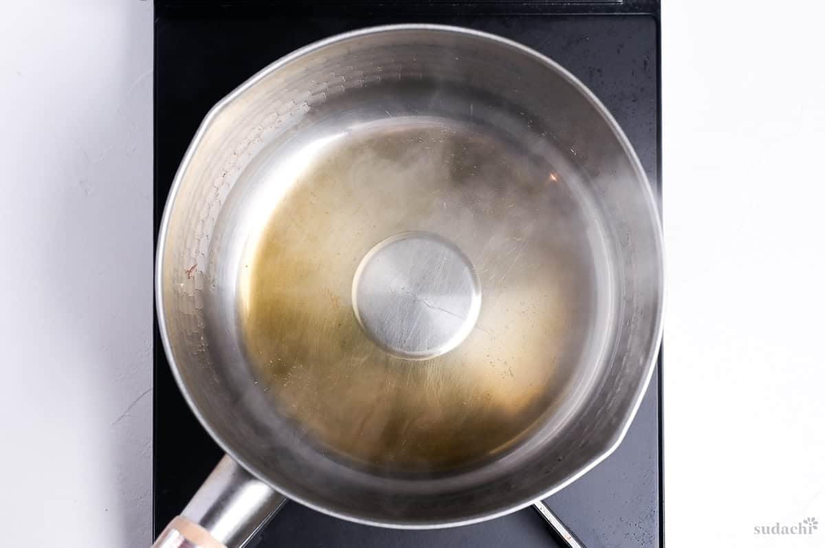 cooking mirin in a pot to burn off some of the alcohol for udon noodle soup