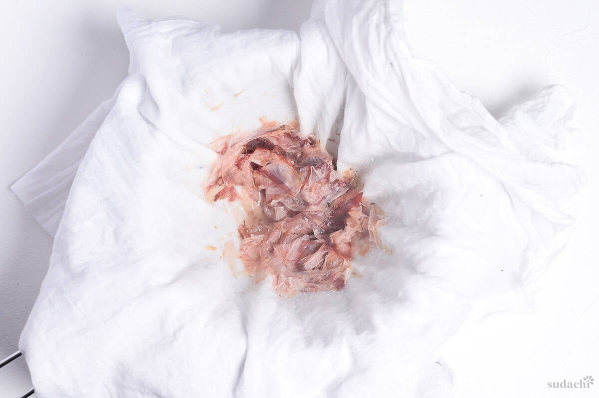 katsuobushi (bonito flakes) in a white cloth after straining dashi