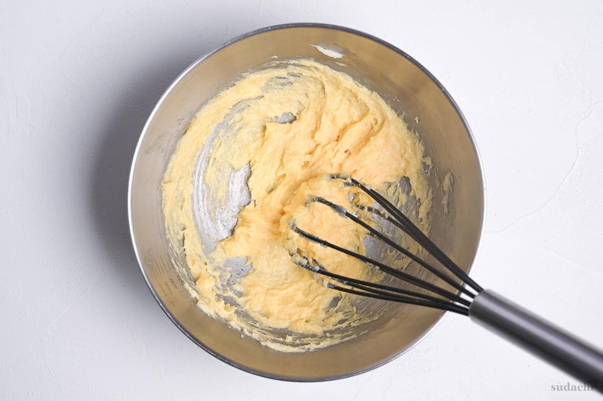 creamed butter and sugar with egg in a steel mixing bowl with whisk