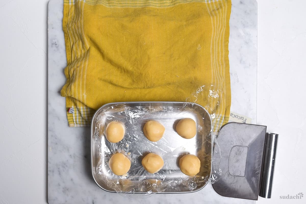 melon pan cookie dough rolled into six balls ready for rolling