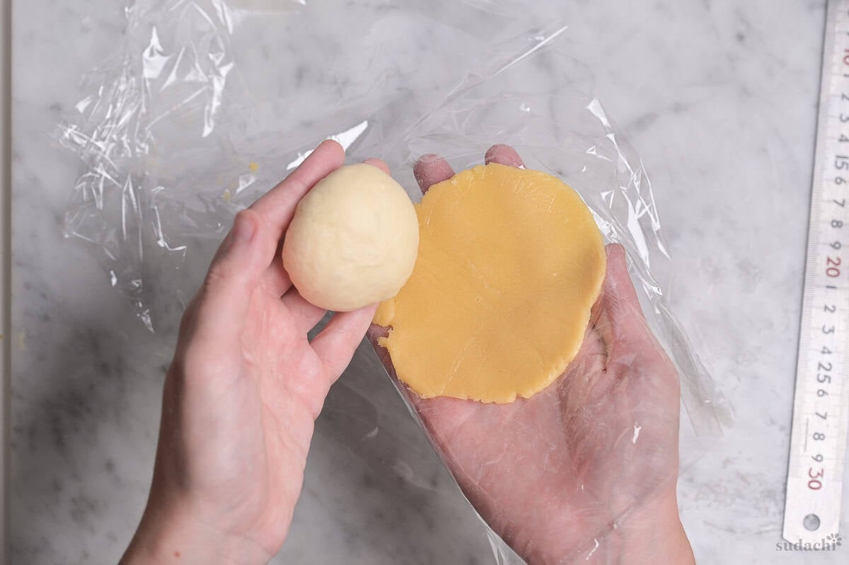 wrapping dough with cookie dough for melon pan