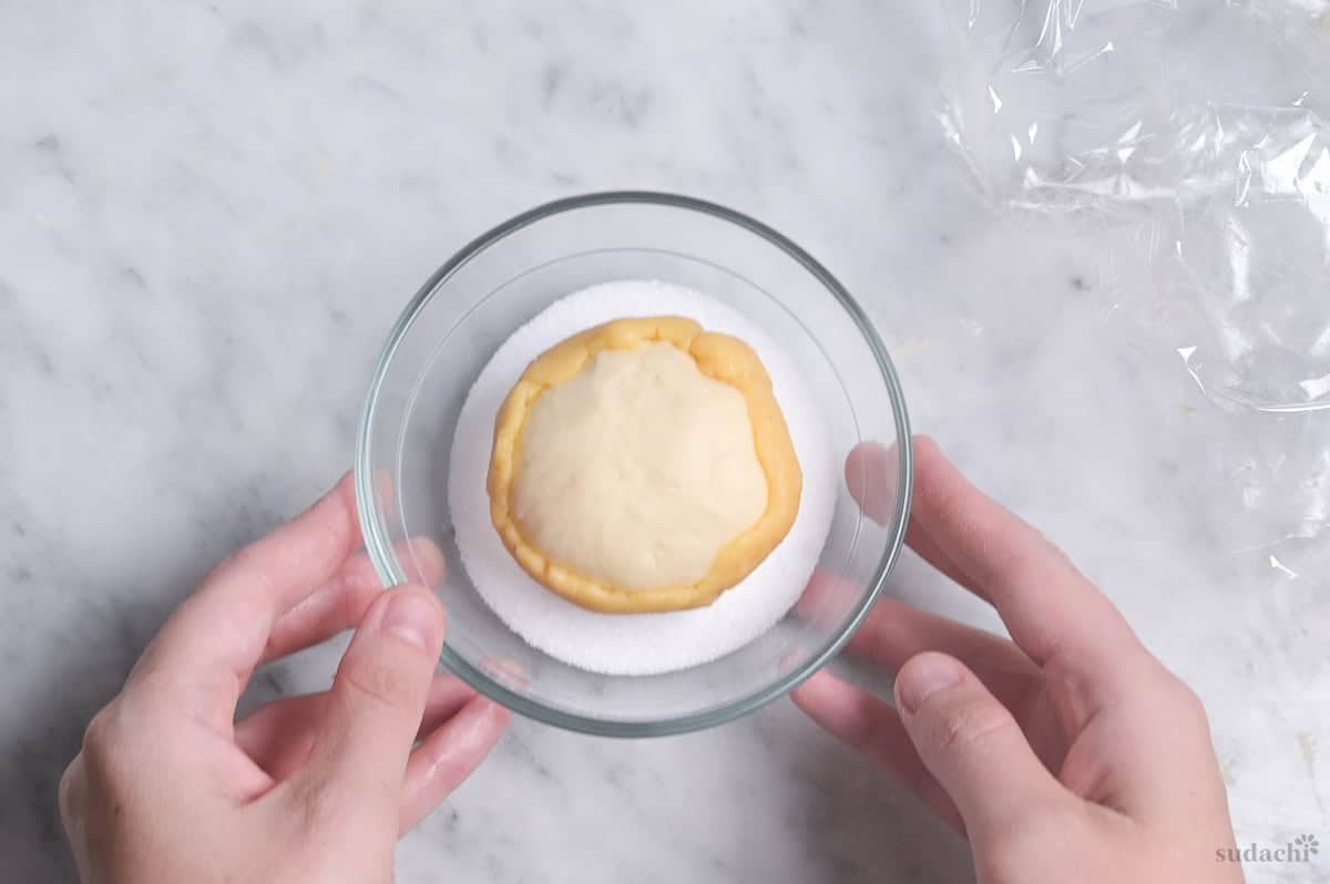 coating cookie dough for melon pan with granulated sugar