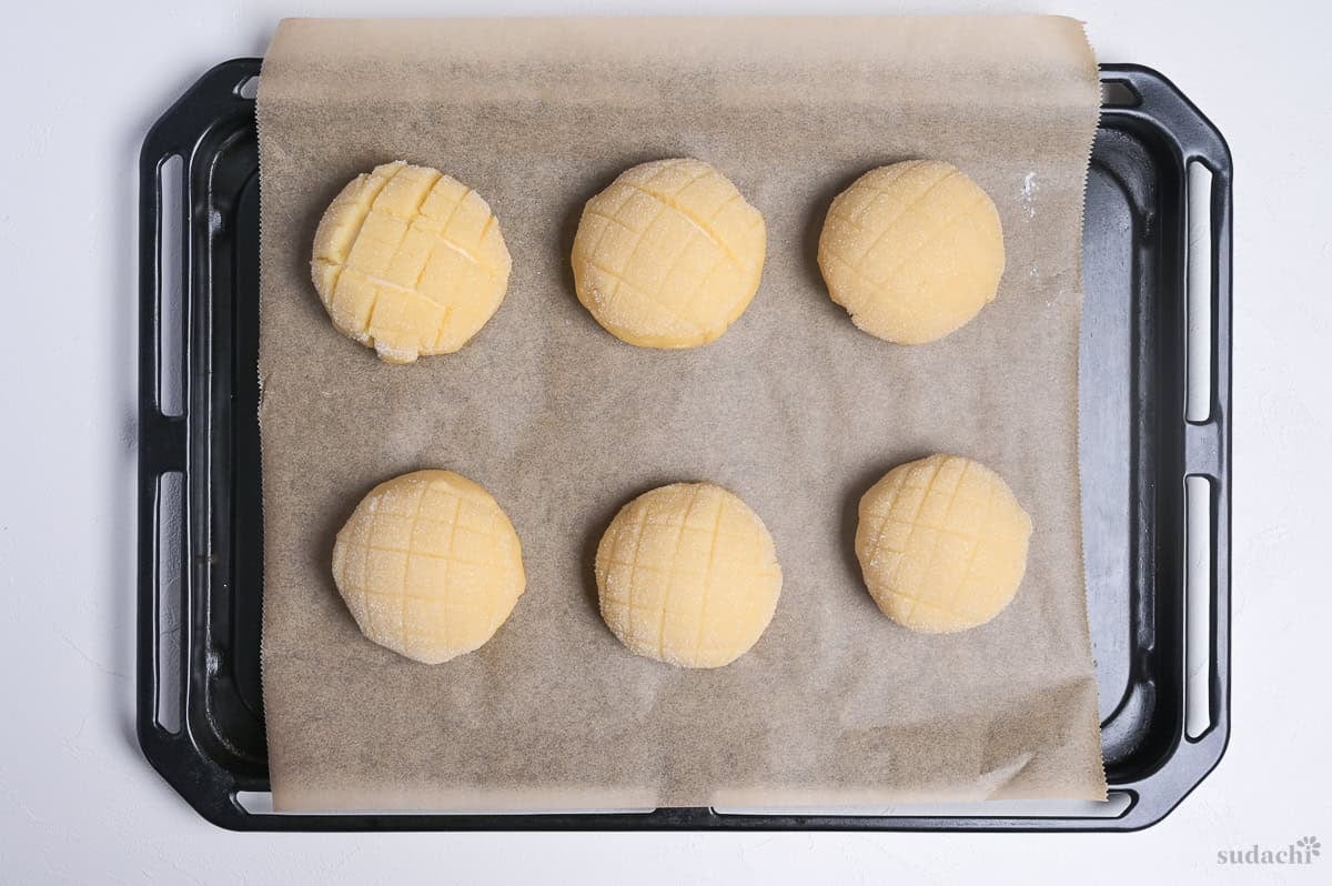 melon pan shaped and spaced apart on a lined baking tray for final rise