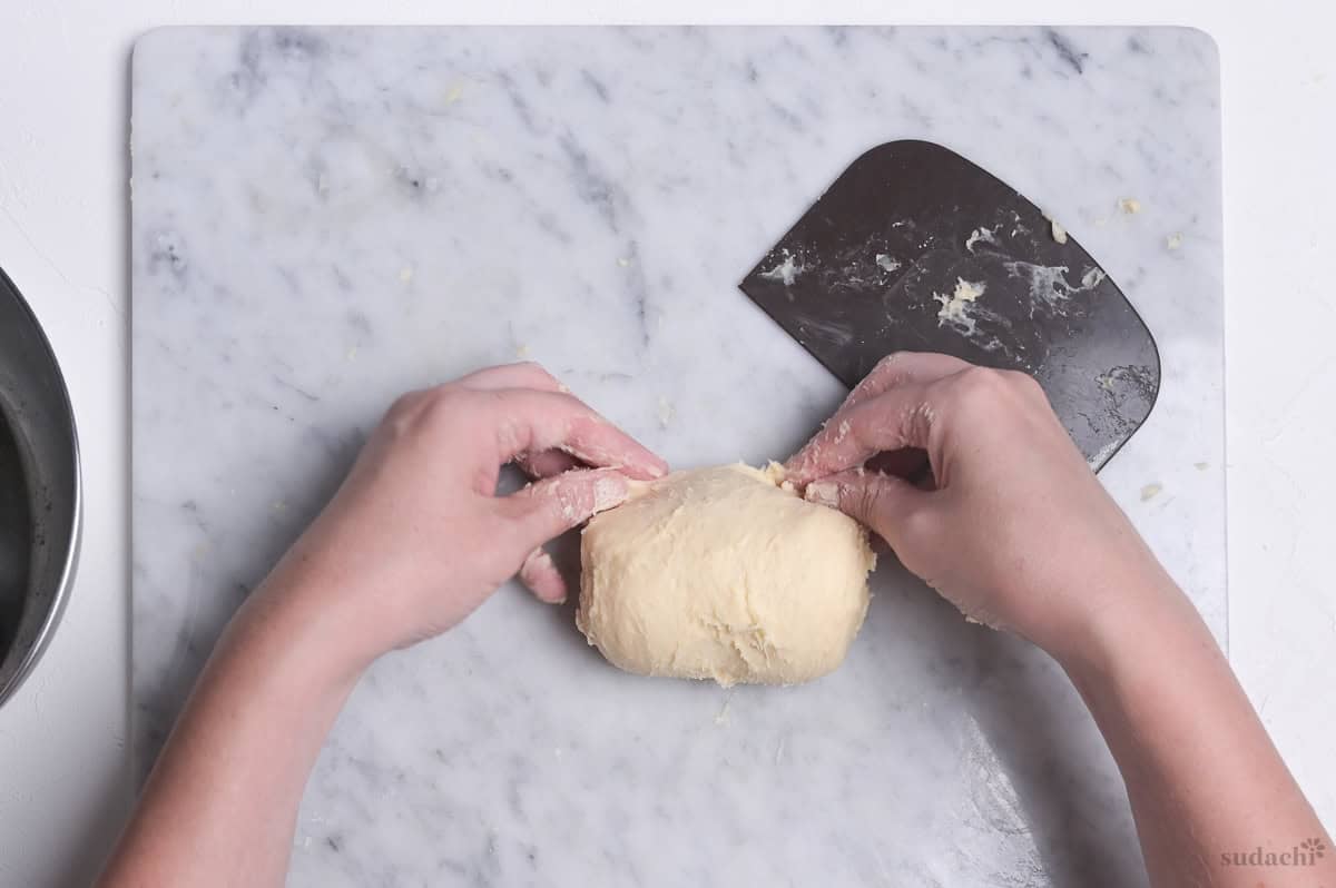 folding melon pan dough over to knead