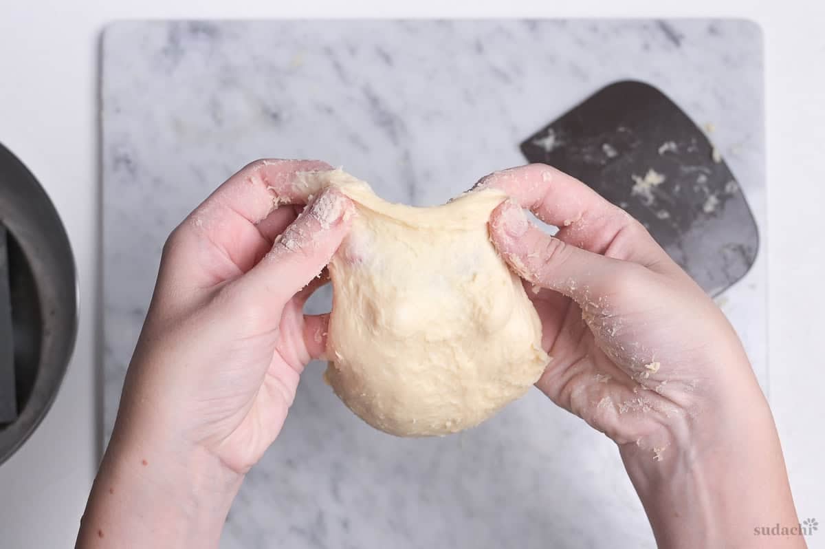 stretching bread dough for windowpane test