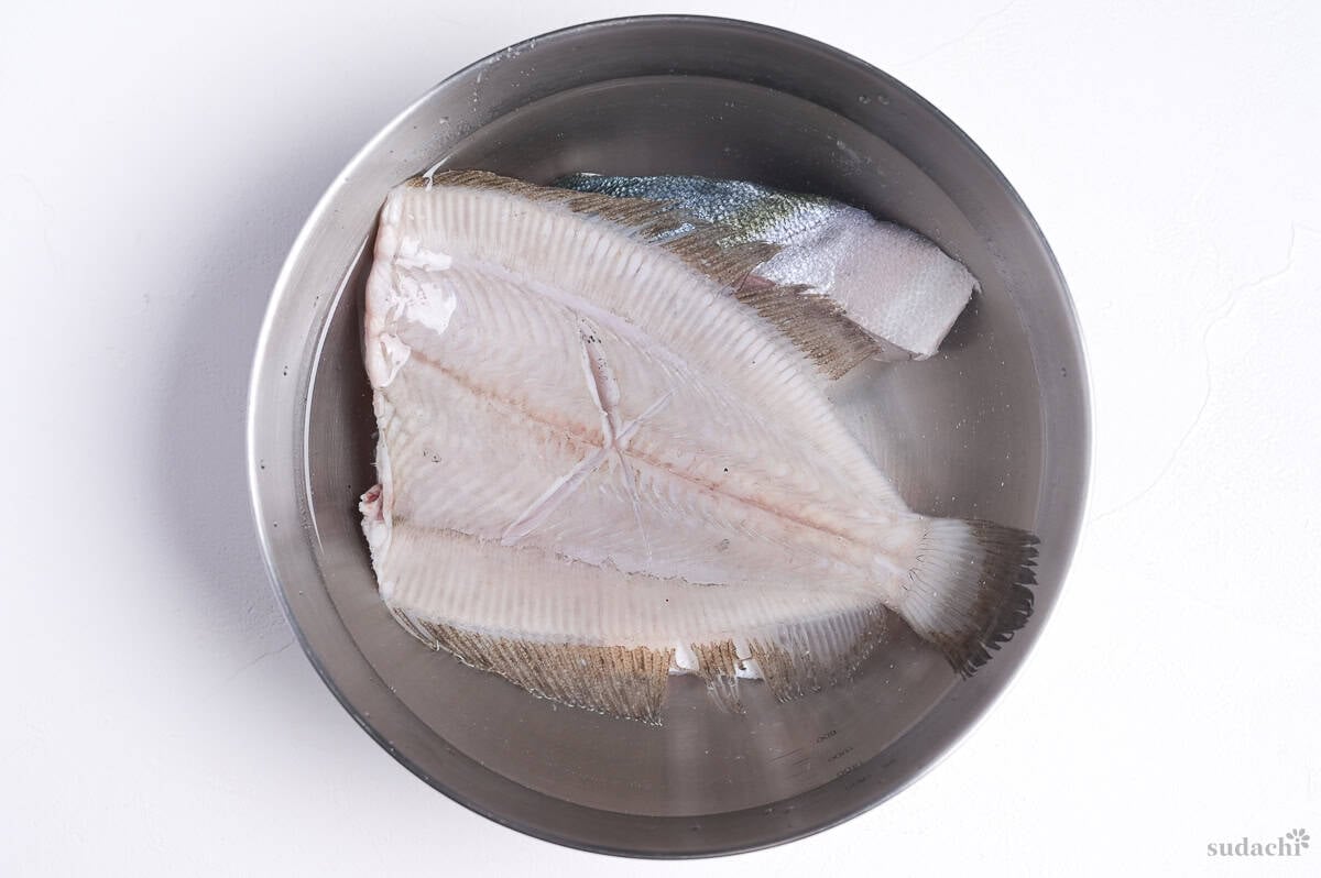 washing fish fillets in a bowl of cold water