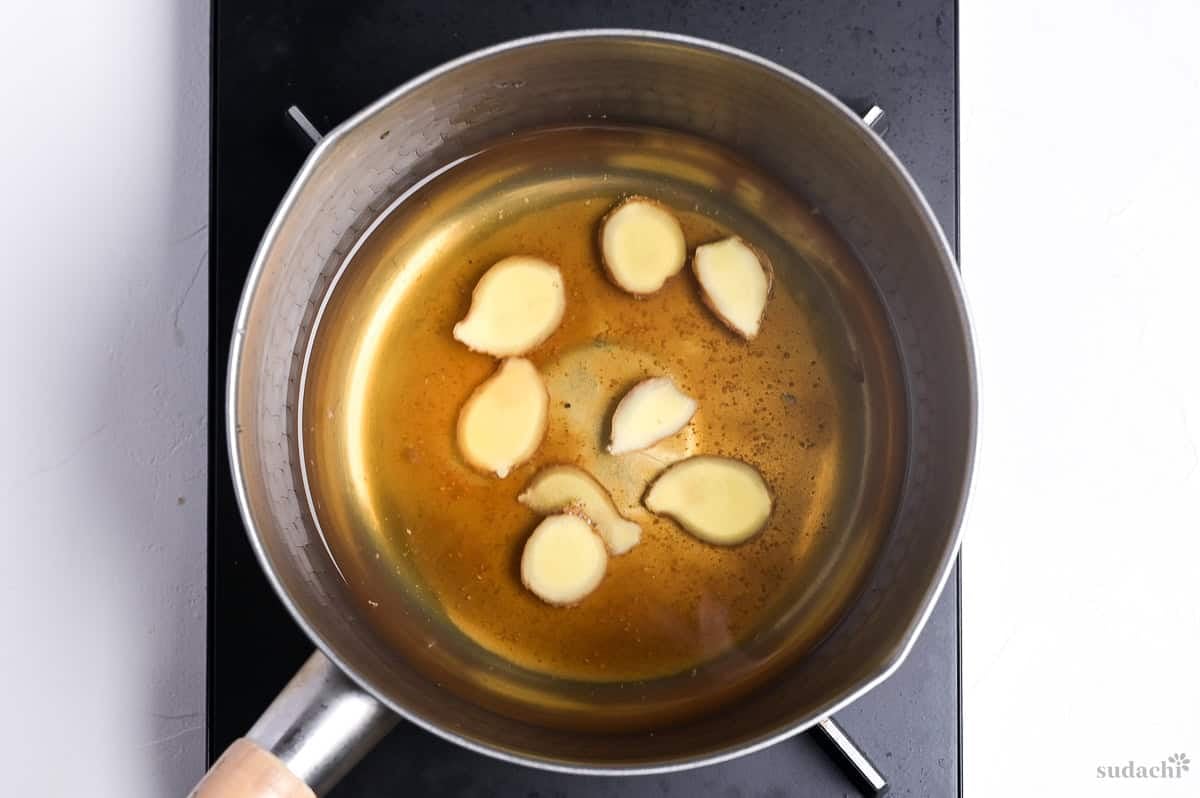 simmering nitsuke broth with ginger in a pot on the stove top