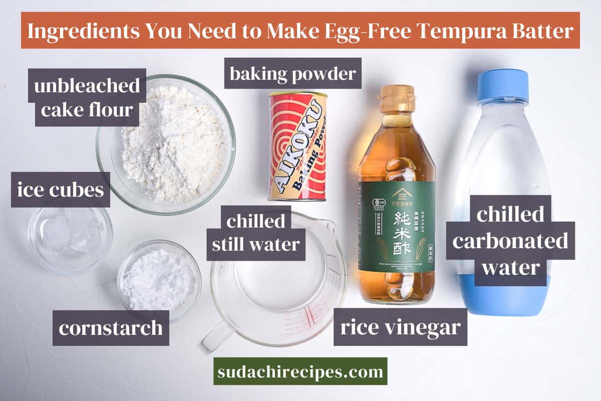 Ingredients to make shojin age (egg-free tempura) batter on a white background with labels. From left to right: unbleached cake flour, ice cubes, cornstarch, baking powder, chilled still water, rice vinegar, chilled carbonated water.