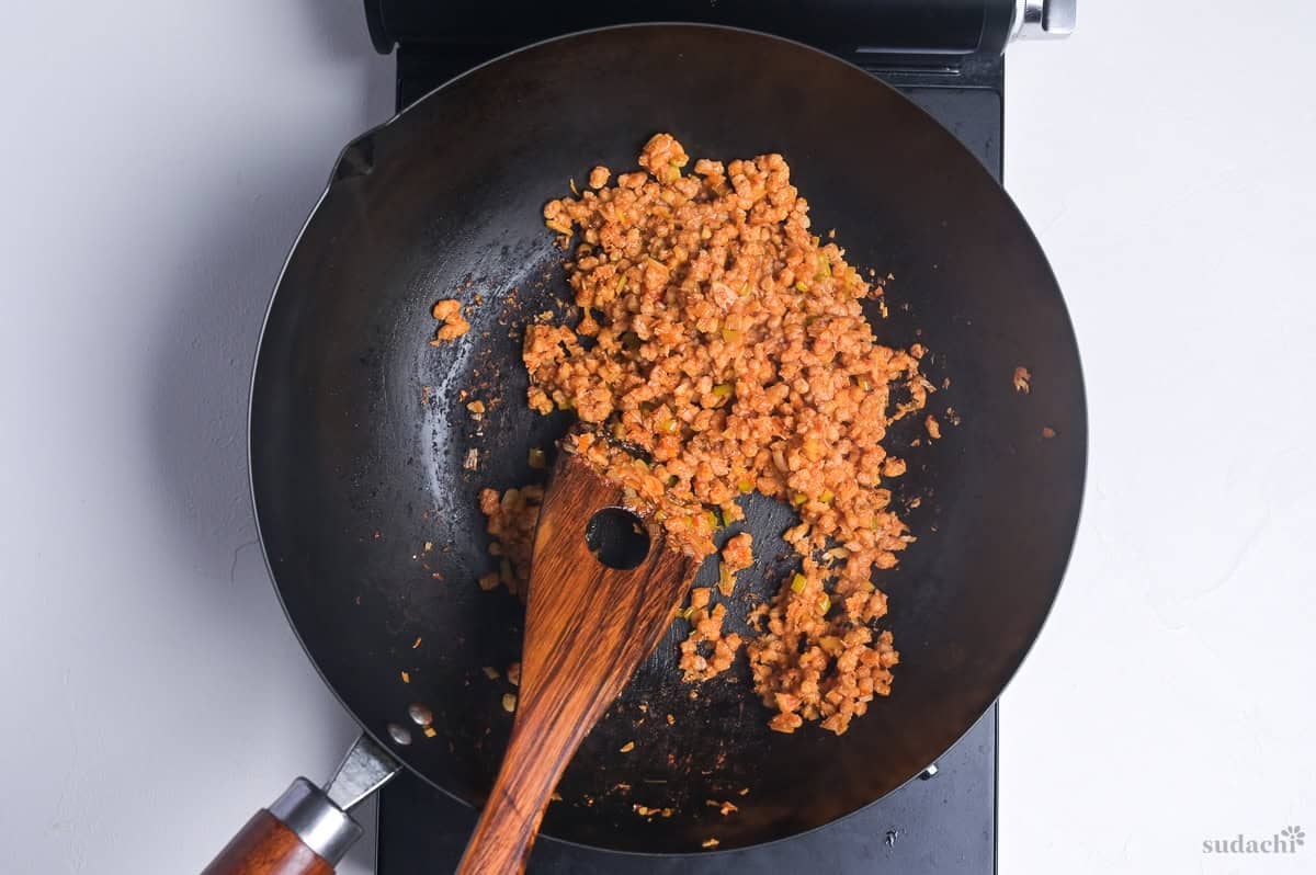 spicy seasoned soy mince in a wok on the stove top to make plant-based mabo nasu